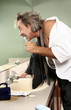 Businessman brushing teeth in the toilet.