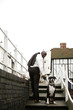 Businessman pulling his stubborn dog.