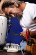 Photo: Man trying to fix his computer. Man trying to fix his computer.