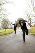 Businessman chasing after another businessman.
