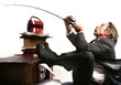 Businessman fishing at his table.