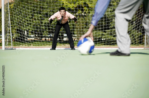 Photo: Businessmen playing football. Businessmen playing football.