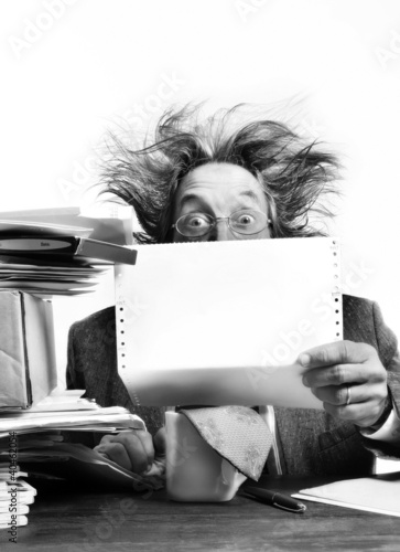 Photo: Businessman reading report. Businessman reading report.