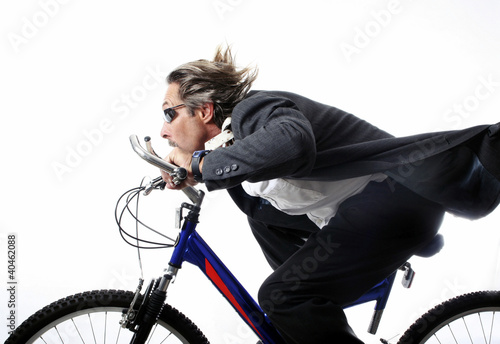 Photo: Businessman cycling at a fast speed. Businessman cycling at a fast speed.