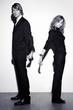 Photo: Businessman and businesswoman being cuffed together. Businessman and businesswoman being cuffed together.