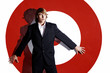Businessman leaning against a dartboard.