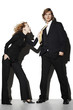 Photo: Businesswoman pulling a businessman's tie. Businesswoman pulling a businessman's tie.