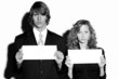 Businessman and businesswoman holding blank papers.
