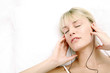 Woman listening to music on the bed.