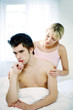 Woman consoling her sulking husband.