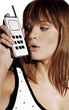 Photo: Woman in bikini talking on the handphone. Woman in bikini talking on the handphone.