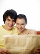 Couple reading newspaper together.