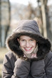 Woman in winter clothing smiling at the camera.