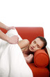Man covering his wife with a blanket.