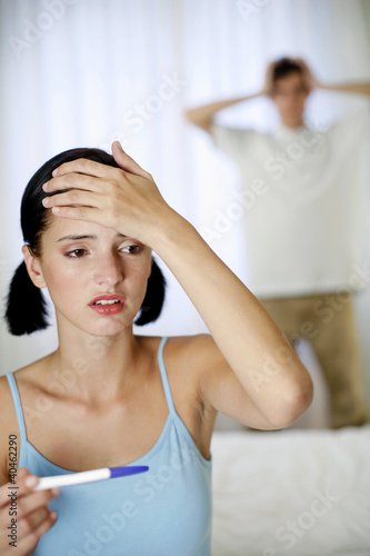Photo: Couple looking depressed after getting the pregnancy test result. Couple looking depressed after getting the pregnancy test result.