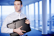 Businessman with a briefcase handcuffed to his wrist.