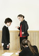 Teacher scolding her student for not completing his homework.