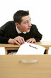 Boy stealing a sheet of exam results.