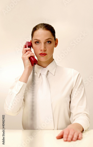 Photo: Businesswoman answering a phone call. Businesswoman answering a phone call.
