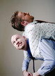 Businessman carrying his drunk friend.