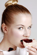 Woman eating biscuit with jam.