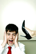 Businessman being kicked on the head.