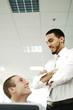 Two businessmen talking and smiling.