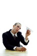 Foto: Businessman playing with a paper plane. Businessman playing with a paper plane.