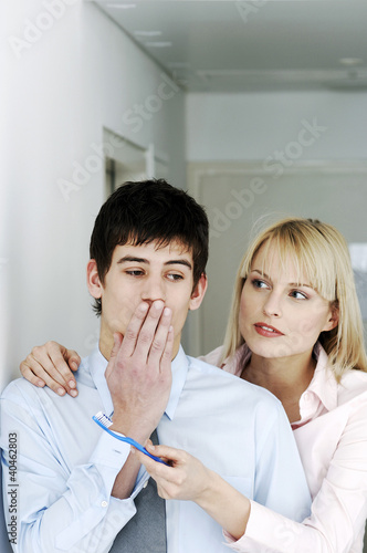 Photo: Businesswoman offering her colleague a toothbrush. Businesswoman offering her colleague a toothbrush.