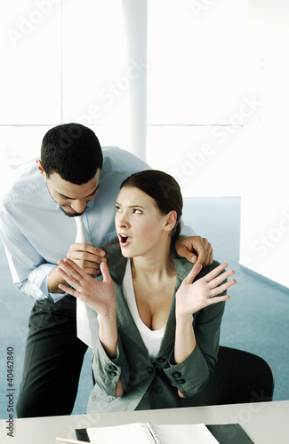 Photo: Businessman flirting with his colleague. Businessman flirting with his colleague.