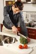 Photo: Man cutting vegetables in the kitchen. Man cutting vegetables in the kitchen.