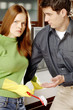 Photo: Man consoling his angry girlfriend in the kitchen. Man consoling his angry girlfriend in the kitchen.
