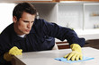 Photo: Man wiping the table. Man wiping the table.