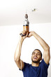 Man drilling the ceiling.