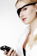 Businesswoman with eye patch text messaging on the cellphone.
