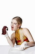 Woman about to bite on a meat.