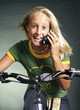 Girl talking on the mobile phone while cycling.