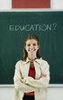 Girl standing in front of the blackboard.