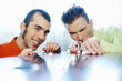 Foto: Businessmen playing with candies. Businessmen playing with candies.