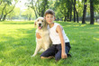 Photo: Tennager boy in the park with a dog Tennager boy in the park with a dog