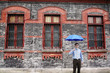 Businessman holding an umbrella.
