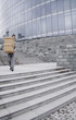 Photo: Businessman carrying a stack of boxes down the stairs. Businessman carrying a stack of boxes down the stairs.