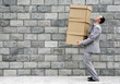 Photo: Businessman carrying a stack of boxes. Businessman carrying a stack of boxes.