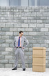 Photo: Businessman looking at a stack of boxes. Businessman looking at a stack of boxes.