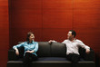 Couple sitting on the couch talking.