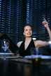 Foto: Woman raising her hand while holding a menu Woman raising her hand while holding a menu
