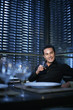Man smiling while holding a glass of wine
