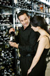 Couple choosing wine at wine cellar