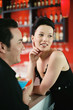 Man and woman standing at the bar counter