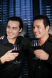 Men holding glasses of wine